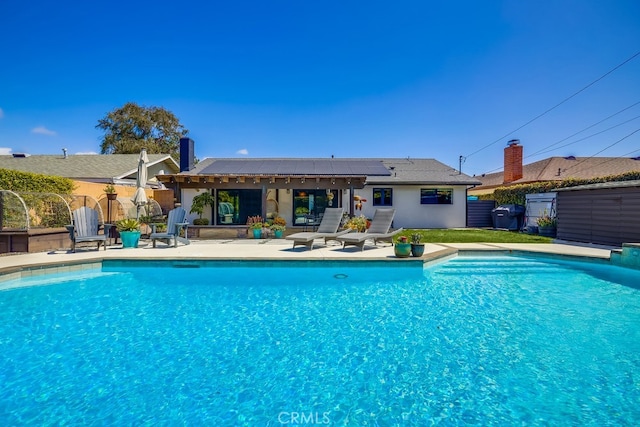 view of swimming pool featuring fence, grilling area, a fenced in pool, and a patio