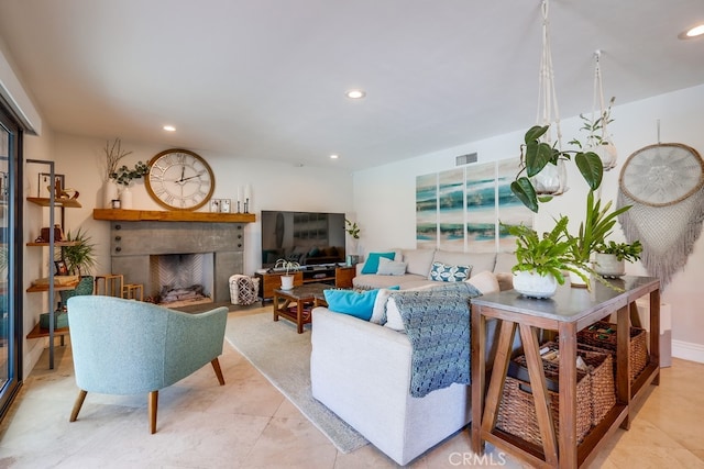 living room with recessed lighting, visible vents, light tile patterned floors, and a fireplace