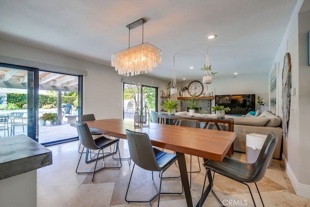 dining area featuring baseboards, recessed lighting, and a chandelier