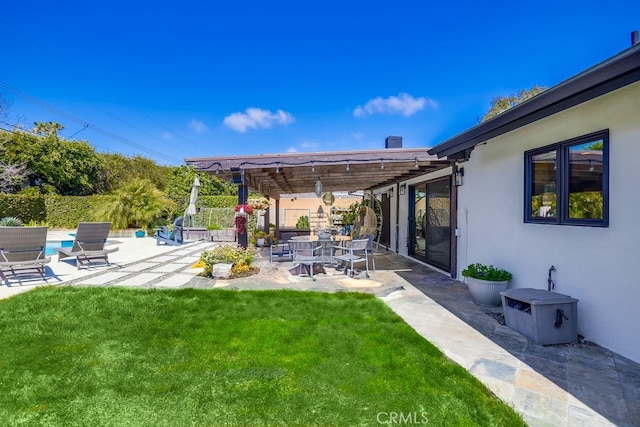 view of yard featuring fence, a patio area, a fenced in pool, and a pergola