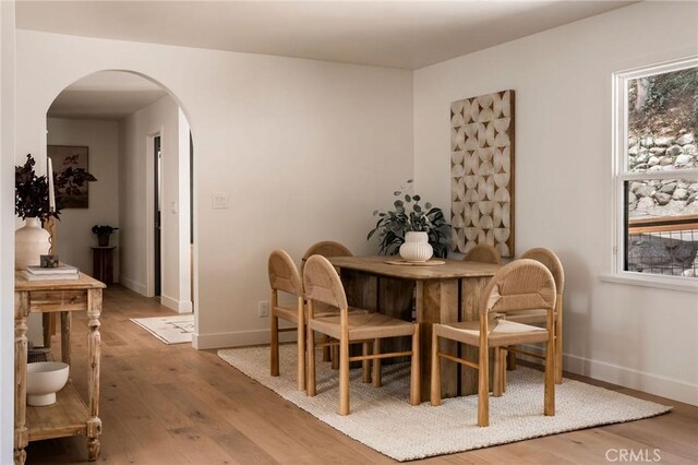 521 Fremont Dr, Pasadena, CA 91103 - dining area with arched walkways, wood finished floors, and healthy amount of natural light