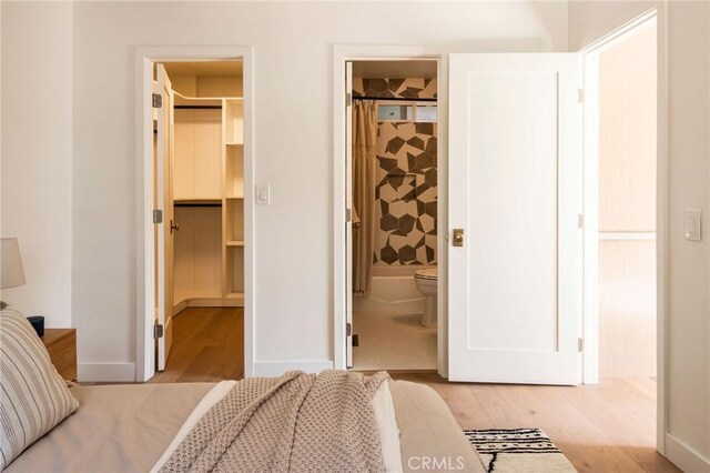 521 Fremont Dr, Pasadena, CA 91103 - bedroom with a walk in closet, light wood-style floors, a closet, and connected bathroom