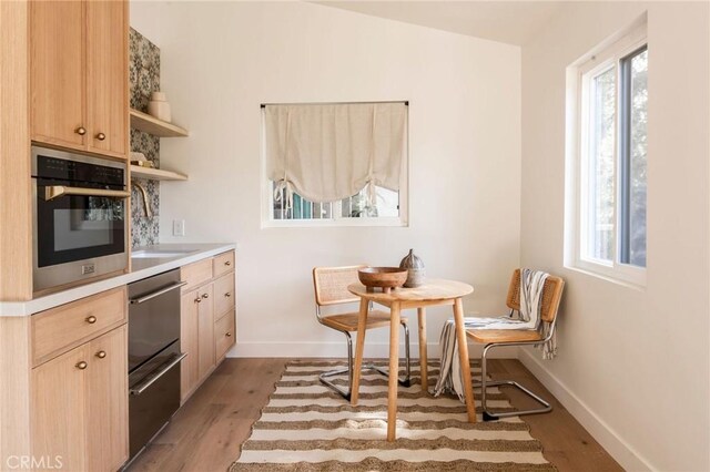 521 Fremont Dr, Pasadena, CA 91103 - kitchen featuring light wood finished floors, light brown cabinetry, stainless steel oven, and light countertops