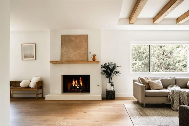 521 Fremont Dr, Pasadena, CA 91103 - living area featuring beam ceiling, wood finished floors, and a lit fireplace