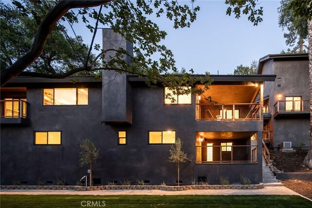 521 Fremont Dr, Pasadena, CA 91103 - rear view of house with a balcony, stairs, stucco siding, and a lawn