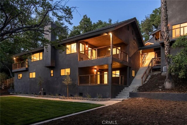 521 Fremont Dr, Pasadena, CA 91103 - view of front facade featuring a balcony, stairway, stucco siding, and a front yard