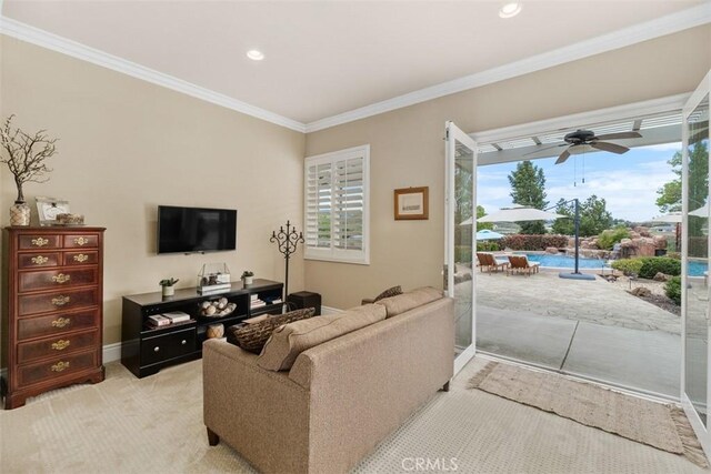 living area featuring a wealth of natural light, recessed lighting, crown molding, and ceiling fan