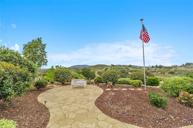 surrounding community featuring a patio and a mountain view