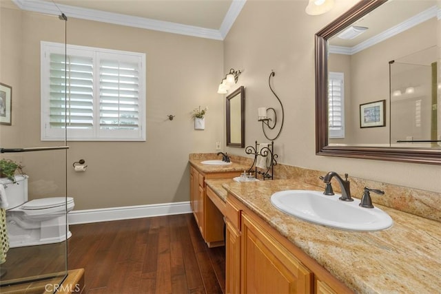 full bath with wood-type flooring, a sink, ornamental molding, and baseboards