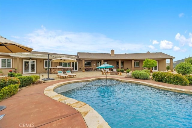 view of swimming pool with a patio, french doors, and ceiling fan