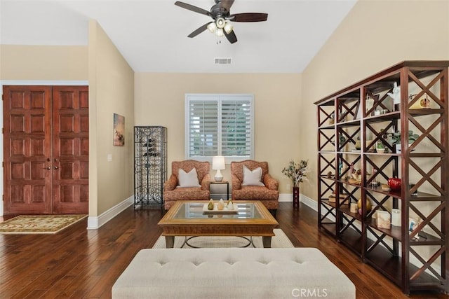 living room featuring visible vents, baseboards, hardwood / wood-style floors, and ceiling fan