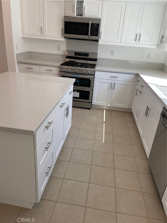 267 N N Magnolia Ave Unit 2, Anaheim, CA 92801 - kitchen with stainless steel appliances, light tile patterned floors, and white cabinetry