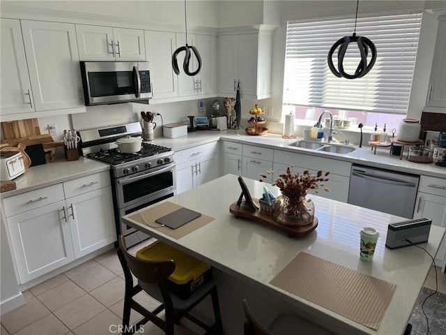 267 N N Magnolia Ave Unit 2, Anaheim, CA 92801 - kitchen with a sink, light countertops, appliances with stainless steel finishes, white cabinetry, and light tile patterned flooring