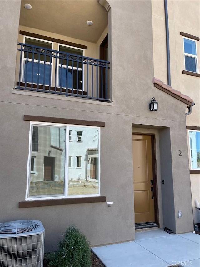 267 N N Magnolia Ave Unit 2, Anaheim, CA 92801 - doorway to property with a balcony, cooling unit, and stucco siding