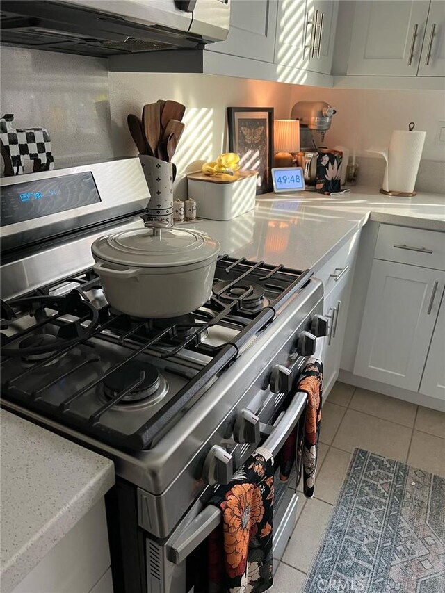 267 N N Magnolia Ave Unit 2, Anaheim, CA 92801 - kitchen with white cabinets, light tile patterned floors, light countertops, and stainless steel gas stove