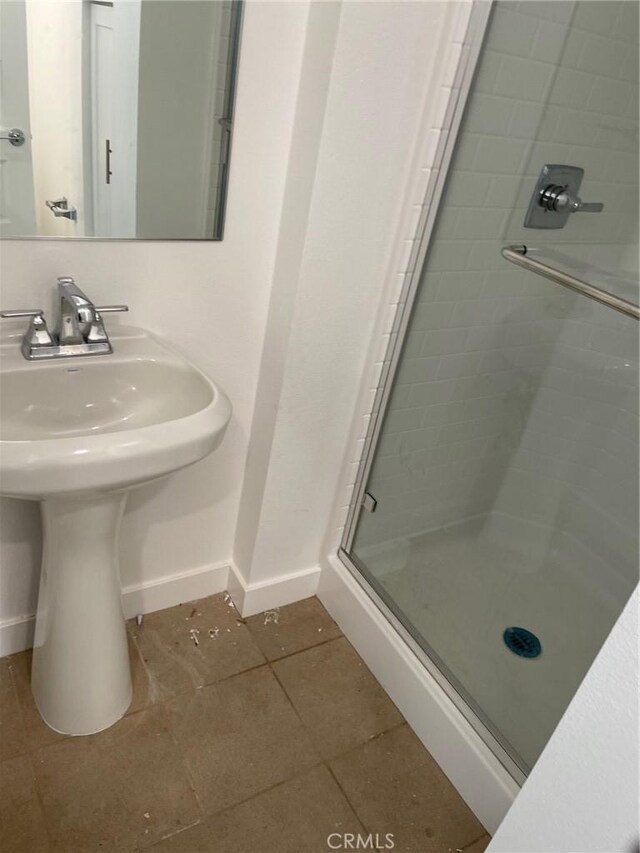 267 N N Magnolia Ave Unit 2, Anaheim, CA 92801 - bathroom featuring a shower stall, a sink, baseboards, and tile patterned flooring