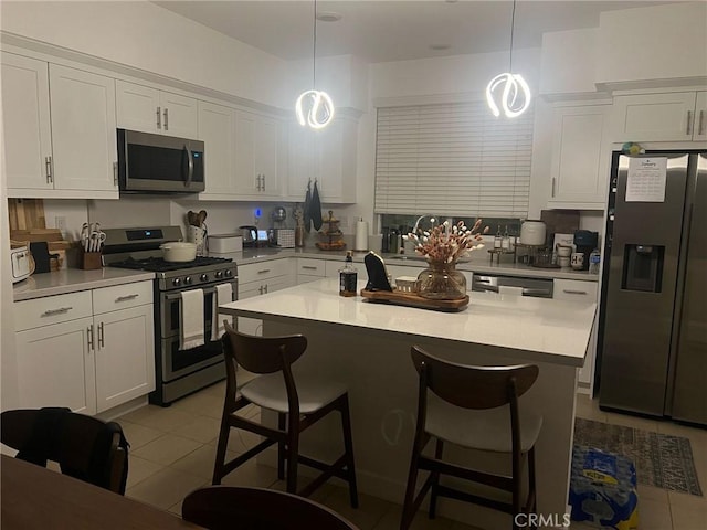 267 N N Magnolia Ave Unit 2, Anaheim, CA 92801 - kitchen featuring white cabinetry, appliances with stainless steel finishes, a kitchen breakfast bar, and light tile patterned flooring