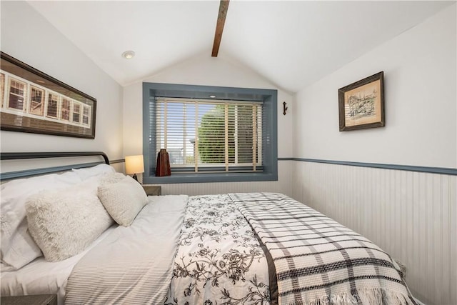 bedroom featuring lofted ceiling with beams