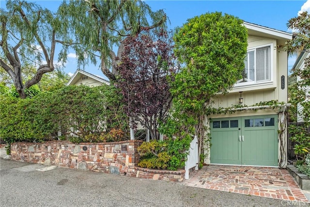 obstructed view of property with a garage