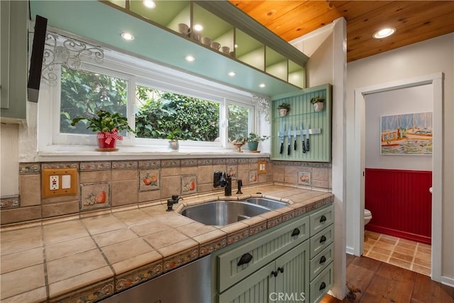bar featuring a wainscoted wall, dark wood-style floors, a sink, decorative backsplash, and wood ceiling