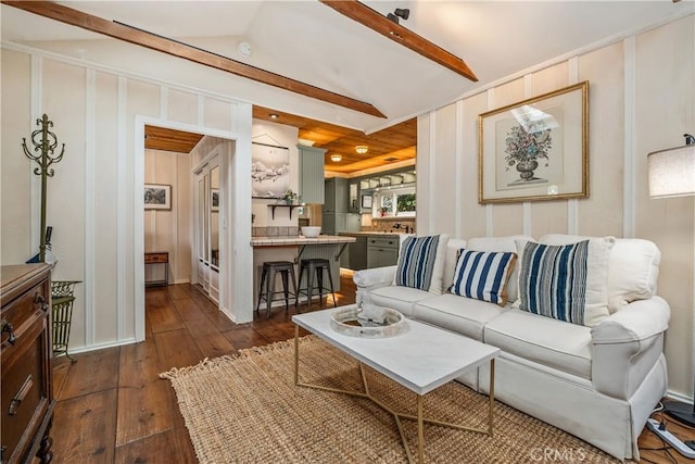 living room featuring dark wood-style flooring and vaulted ceiling with beams