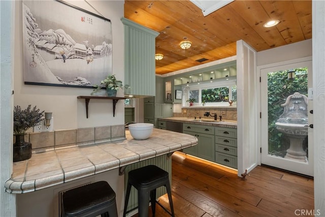 bar featuring wood ceiling, hardwood / wood-style flooring, a sink, and a healthy amount of sunlight