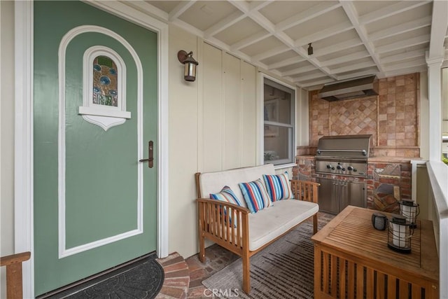 entrance to property with stone siding and exterior kitchen