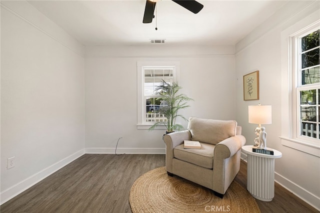 sitting room featuring visible vents, baseboards, ceiling fan, and wood finished floors