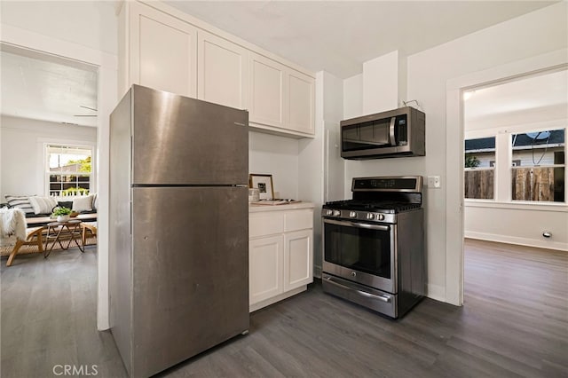 kitchen featuring white cabinetry, dark wood finished floors, and stainless steel appliances