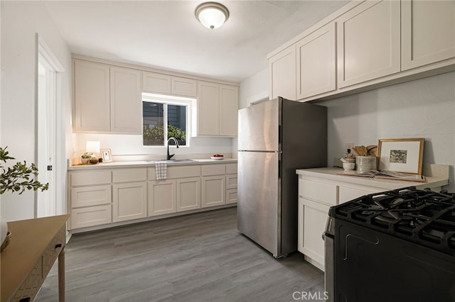 411 A St, Orland, CA 95963 - kitchen featuring a sink, appliances with stainless steel finishes, light countertops, light wood finished floors, and white cabinets