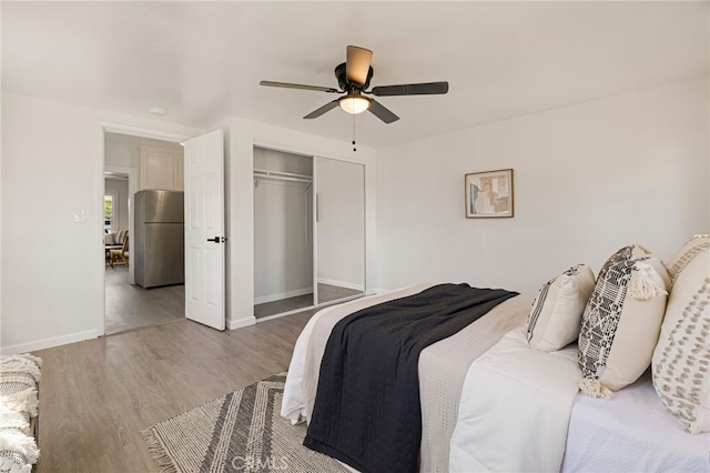 411 A St, Orland, CA 95963 - bedroom featuring freestanding refrigerator, a closet, wood finished floors, ceiling fan, and baseboards