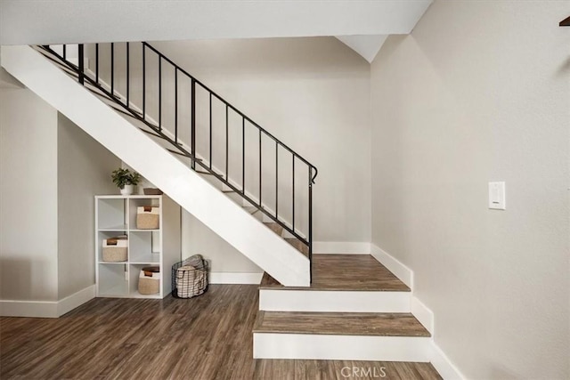 stairway featuring wood finished floors and baseboards