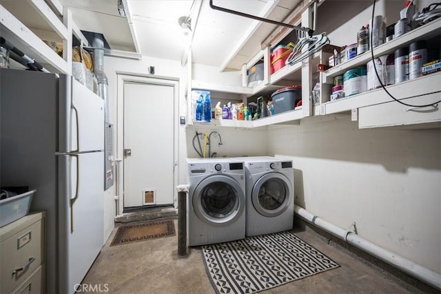 clothes washing area with washer and dryer and laundry area