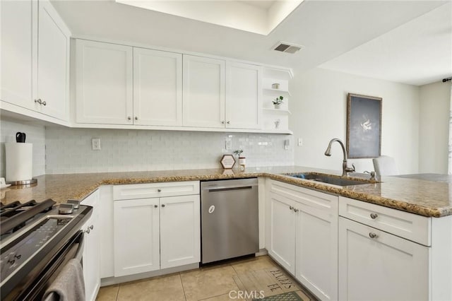 kitchen featuring a peninsula, dishwasher, white cabinetry, and a sink
