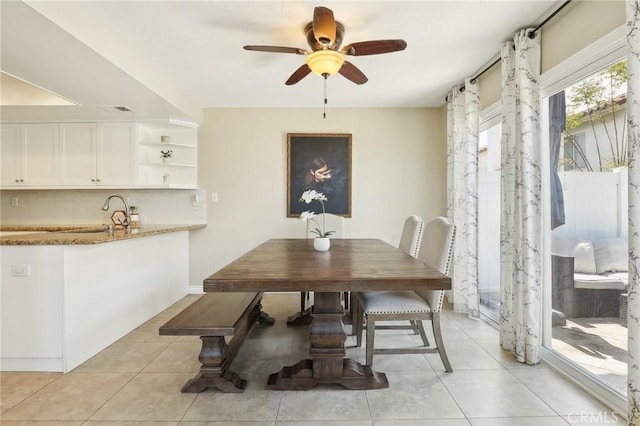 dining area featuring a ceiling fan and light tile patterned flooring
