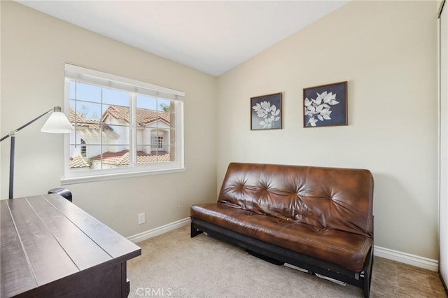 sitting room with carpet flooring, baseboards, and vaulted ceiling