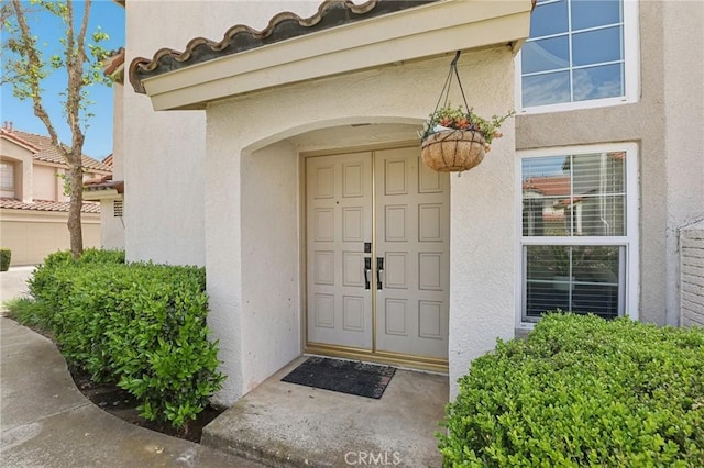 entrance to property featuring stucco siding