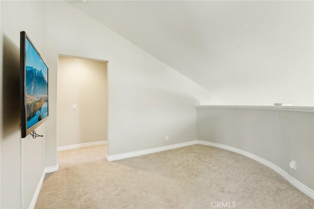bonus room featuring baseboards, light colored carpet, and vaulted ceiling