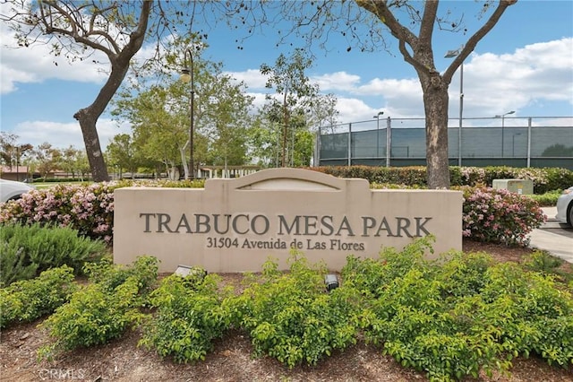 community sign featuring fence
