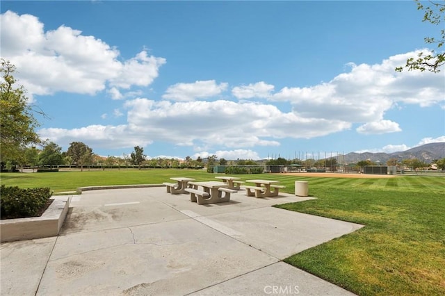 view of community with a mountain view and a lawn