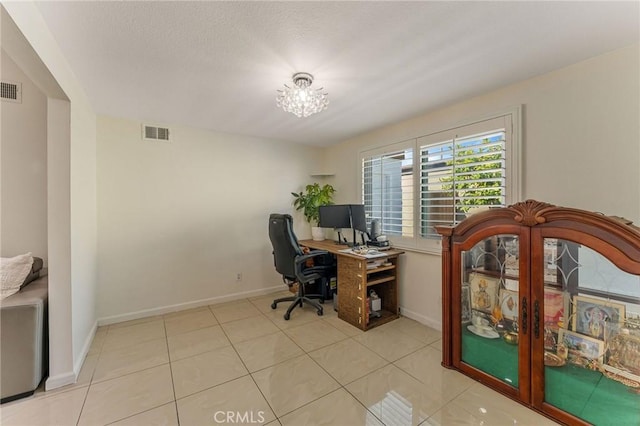 tiled home office featuring visible vents and baseboards