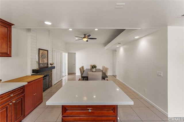 kitchen with light tile patterned floors, light countertops, a ceiling fan, and recessed lighting