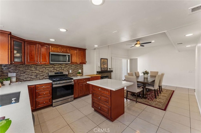kitchen with tasteful backsplash, visible vents, light countertops, and appliances with stainless steel finishes