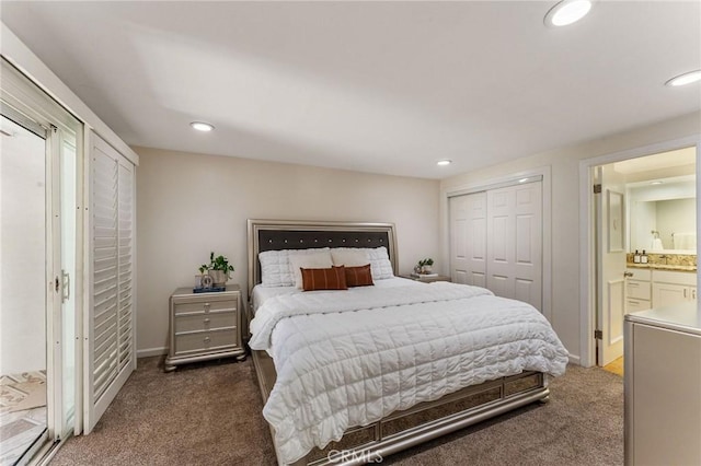 bedroom featuring ensuite bathroom, recessed lighting, and carpet