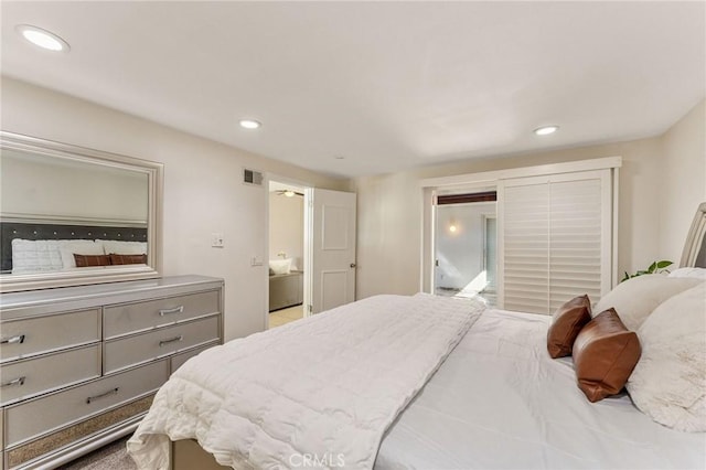 bedroom featuring ensuite bath, visible vents, and recessed lighting