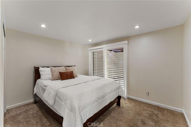 carpeted bedroom featuring recessed lighting and baseboards
