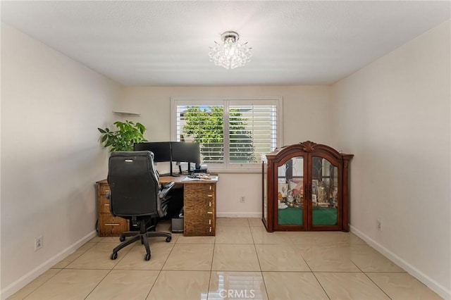 tiled office with baseboards and a notable chandelier