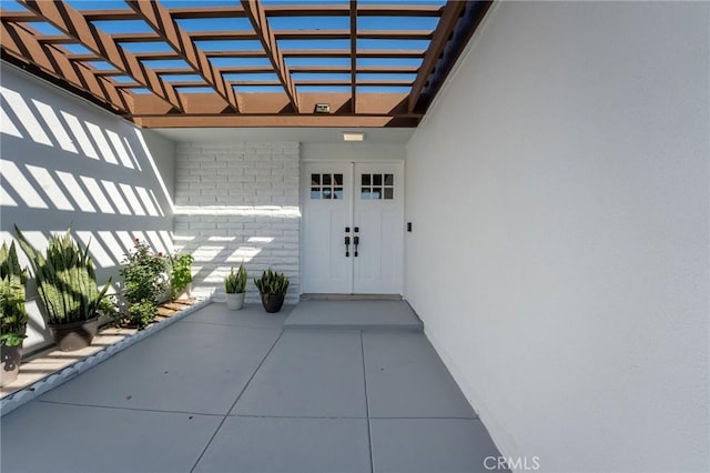 view of exterior entry featuring brick siding