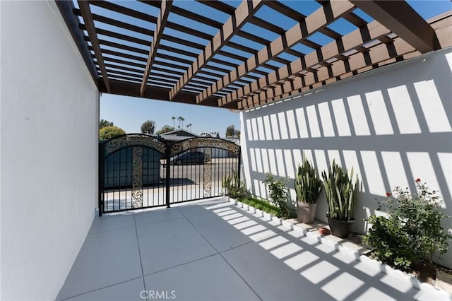view of patio featuring a pergola and a gate