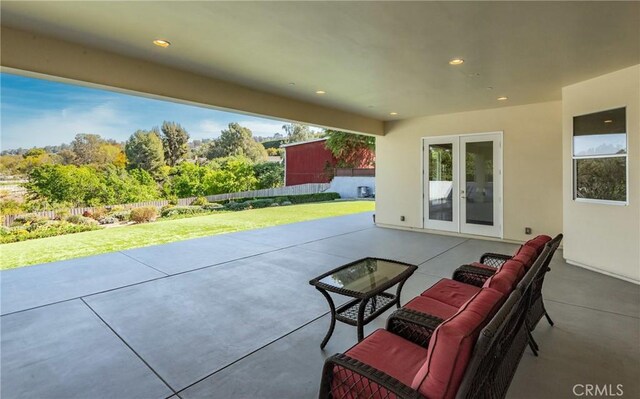 view of patio / terrace with french doors, outdoor lounge area, and fence